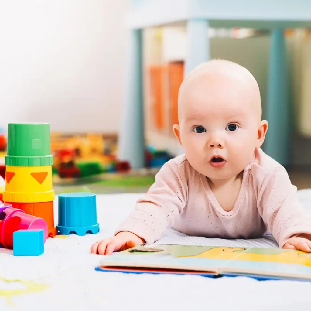 An image of 3 - 6 months baby playing with a toy