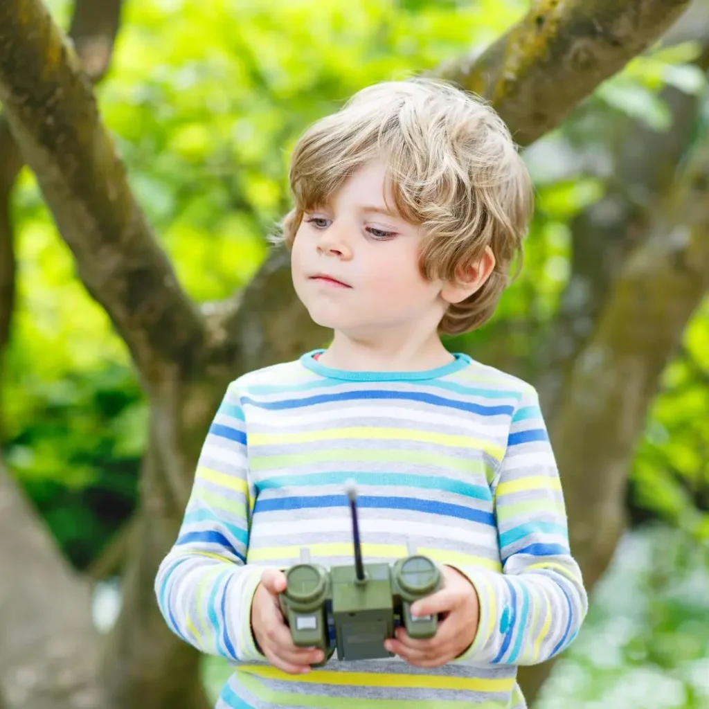 An image of A kid with a Toy Remote