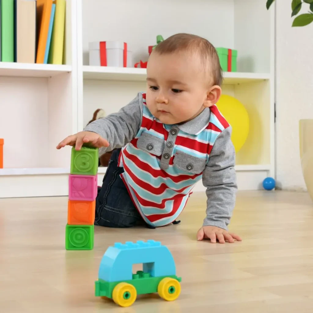 An image of baby playing with toys