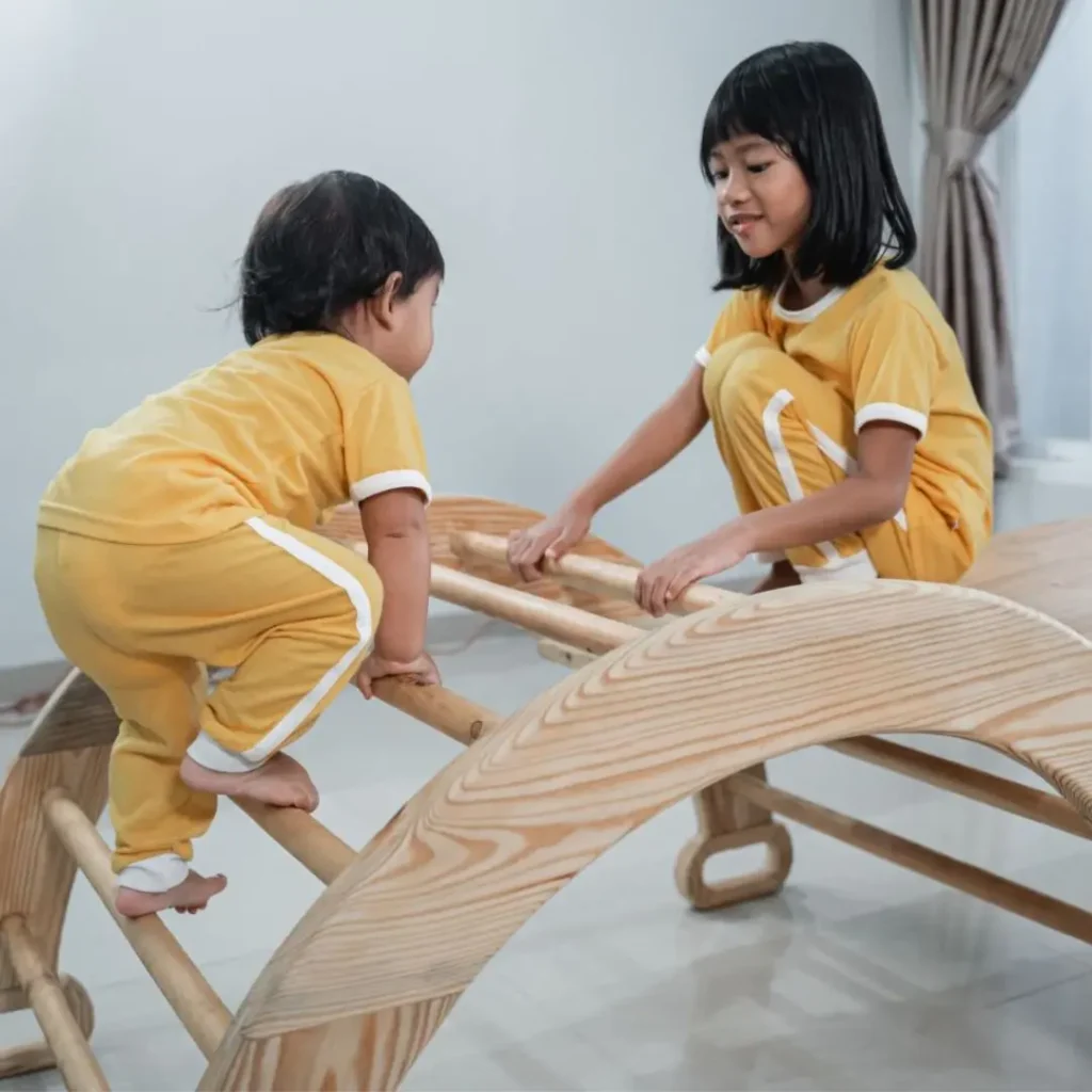 An image of 1 year olds playing with climbing toys