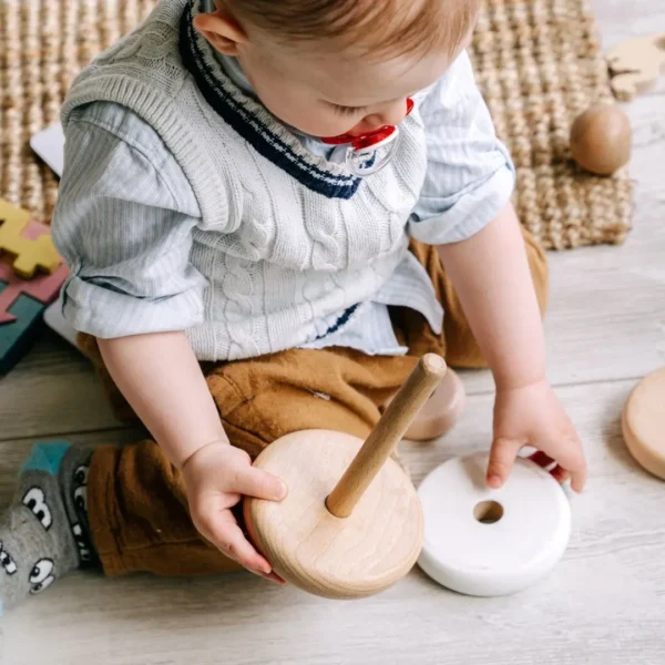 An image of 1 year old playing with wooden montessori toys