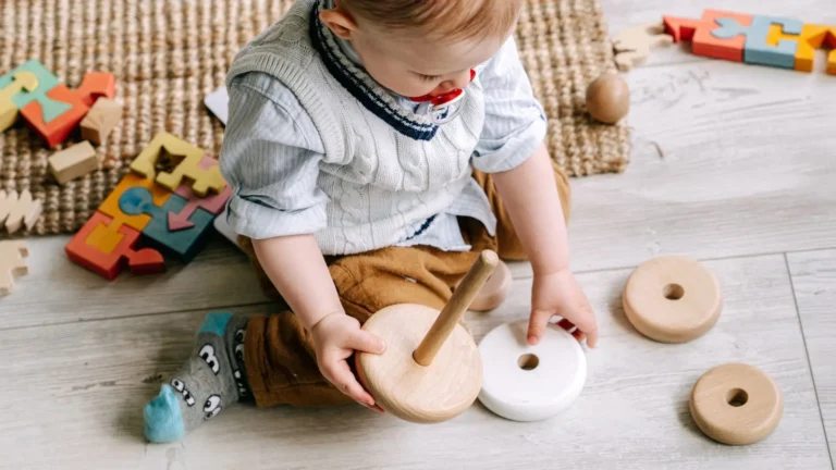 An image of 1 year old playing with wooden montessori toys