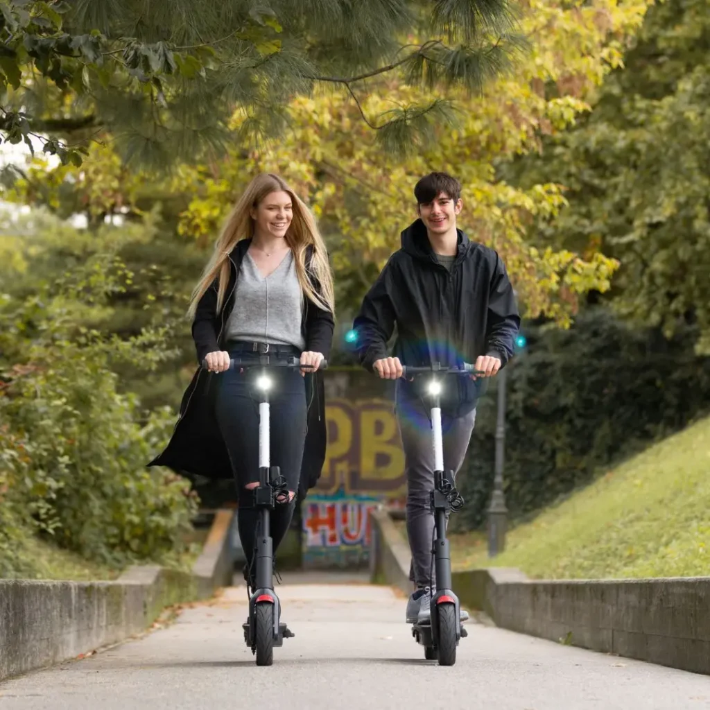 An image of  Adults Riding Electric Scooters