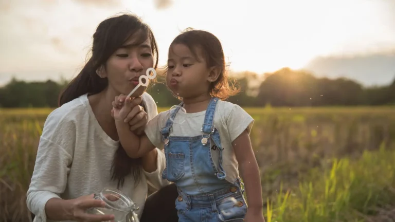 An image of a kid and mother playing with an outdoor toy