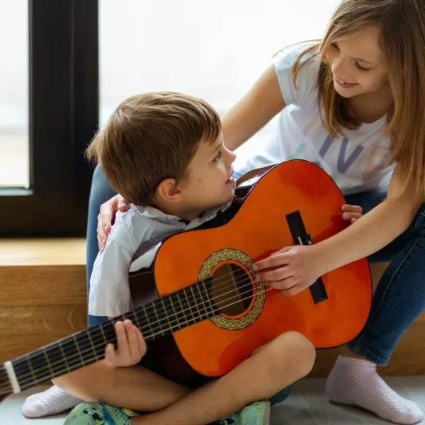 An image of kids playing with a guitar