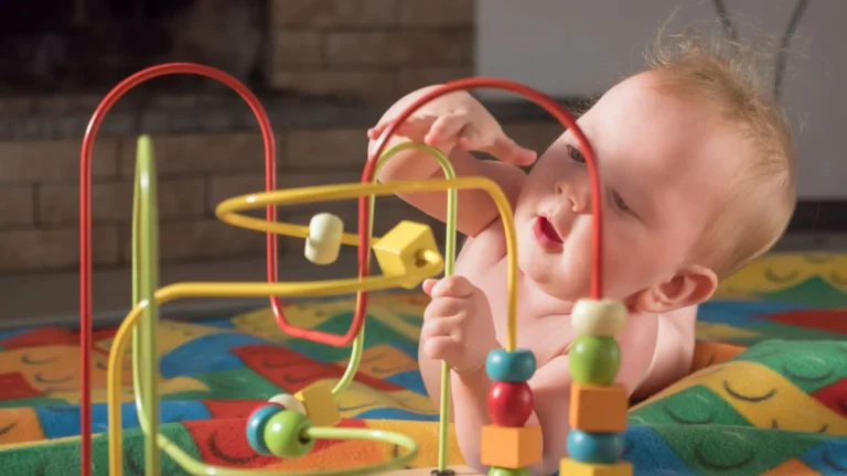 An image of a Baby 9-12 Months Playing with a toy