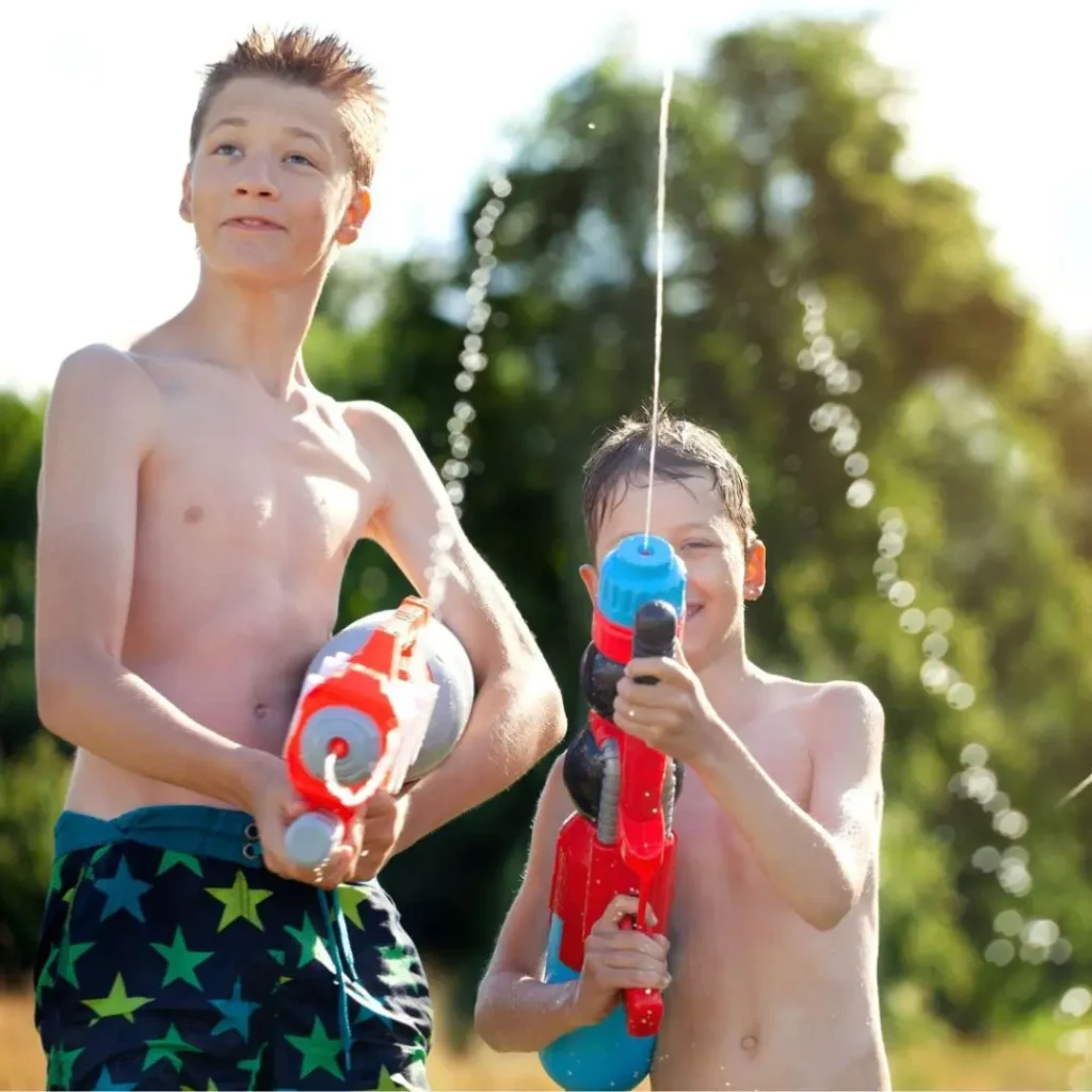 An image of kids playing outdoor with water gun toys