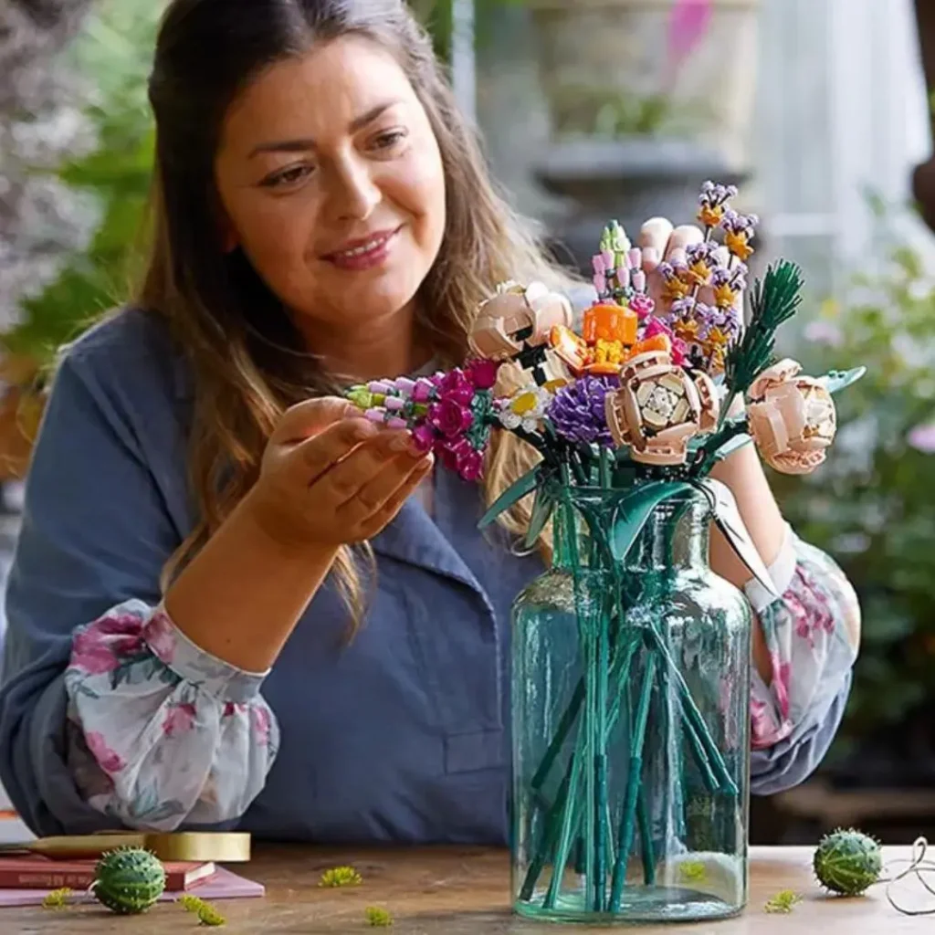 An image of a woman arranging LEGO Flower Bouquet