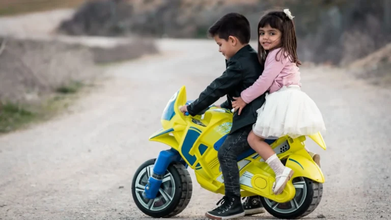 An image of Toddlers playing with a ride on toy outdoor