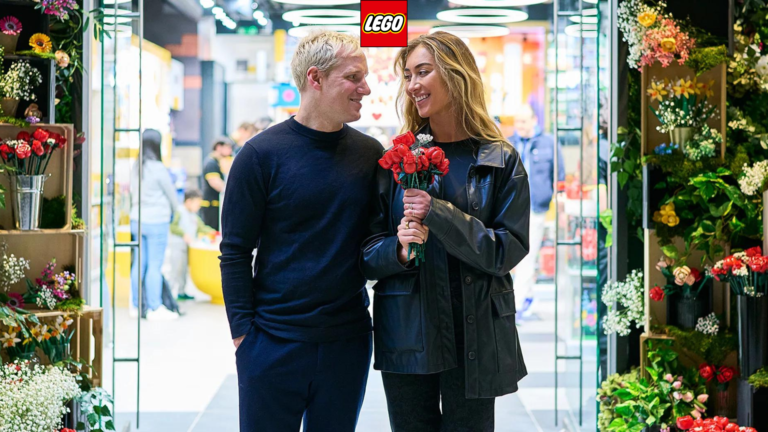 An image of a woman and a man carrying lego flowers and roses